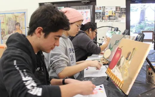 a group of people looking at a book