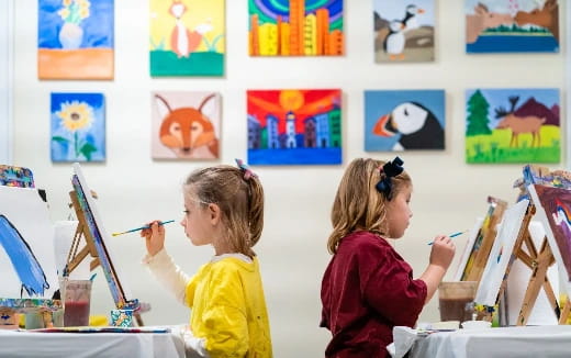 a few young girls painting