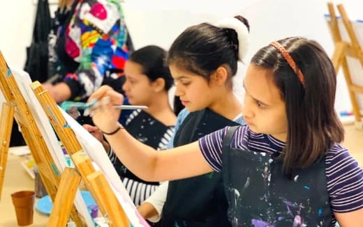 a group of children painting