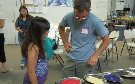 a person and a girl in a room with plates and bowls