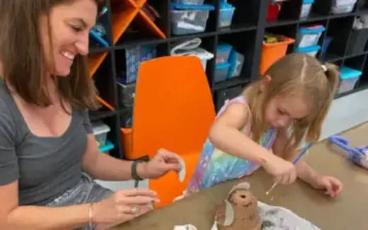 a woman and a girl painting