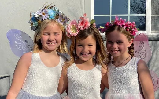 a group of girls wearing flower crowns