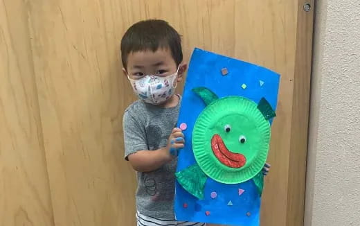 a boy holding a toy