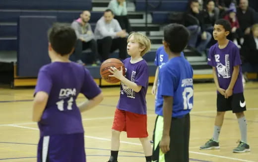 a group of kids playing basketball