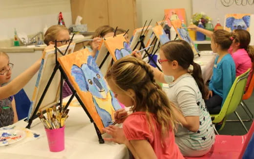 a group of children painting