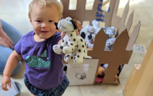 a child holding a stuffed animal