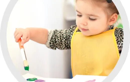 a baby holding a brush