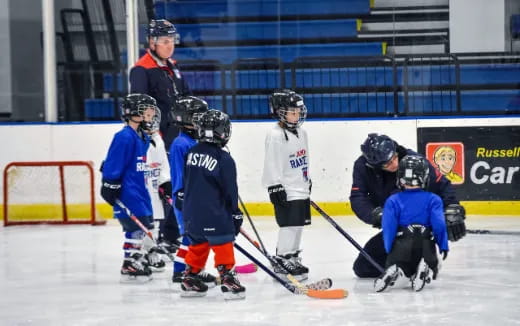 a group of kids playing hockey