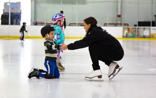 a man and a child on an ice rink
