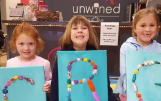 a group of children holding up a book