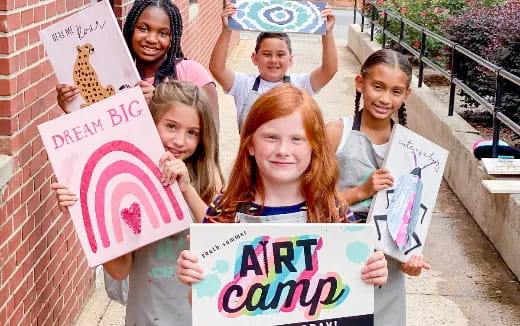 a group of children holding signs