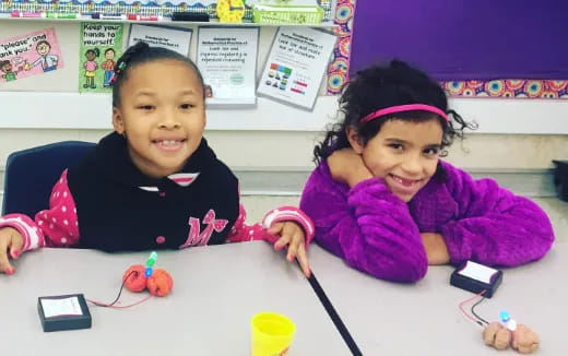 a couple of children sitting at a table