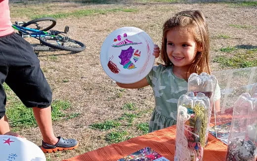 a girl holding a frisbee