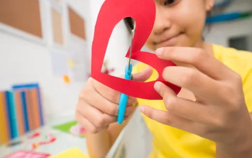 a child holding a red cup