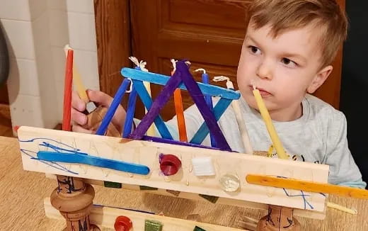 a boy painting with a brush