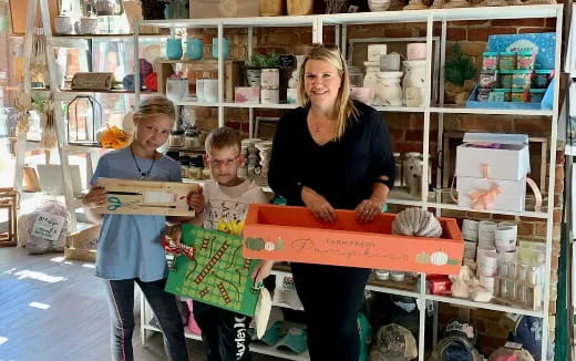 a person and two children holding boxes