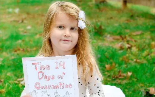 a girl holding a sign