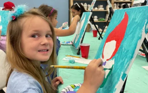 a girl painting a flag