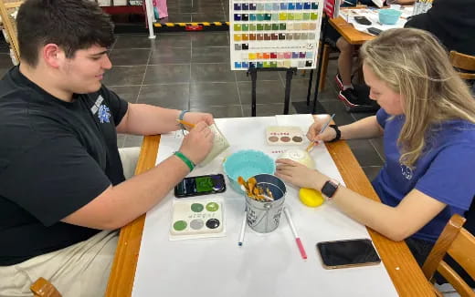 a man and a woman painting