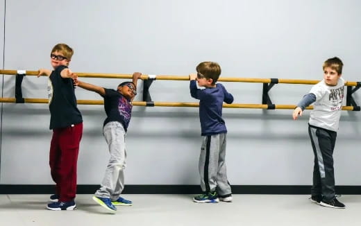 a group of boys holding a bar