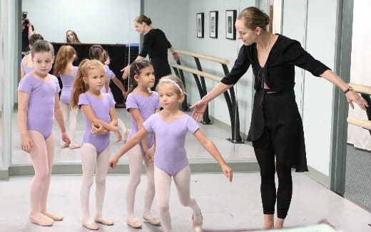 a woman and a group of children dancing