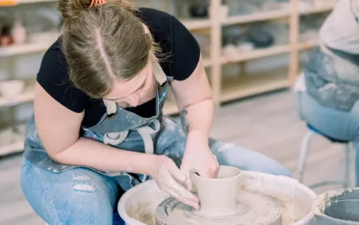 a woman pouring tea into a cup
