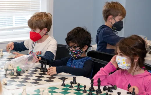 a group of children playing chess