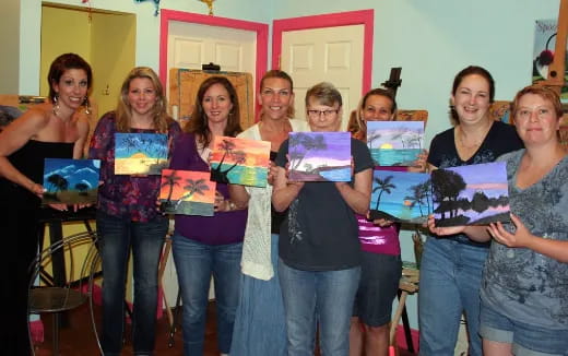 a group of women holding up books