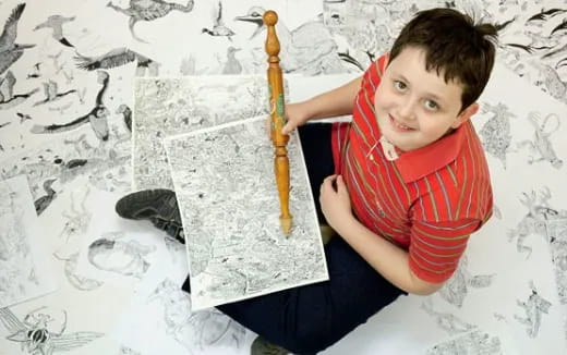 a boy holding a pencil