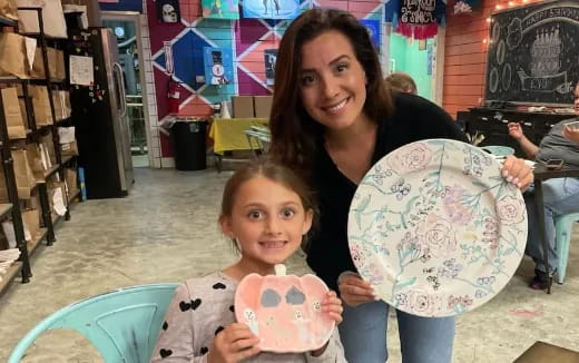 a person and a child holding a globe