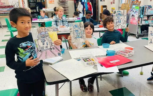 a group of children sitting at a table