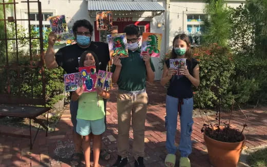 a group of people holding up a book