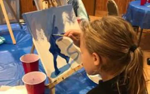 a person painting on a canvas