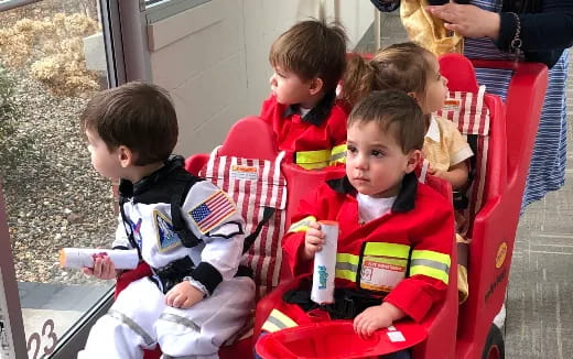 a group of children sitting in chairs