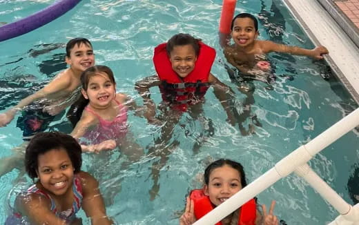 a group of children in a pool