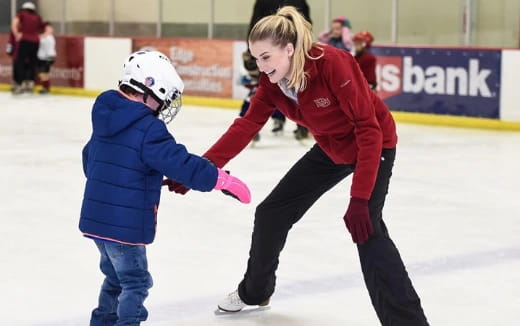 a person and a child ice skating