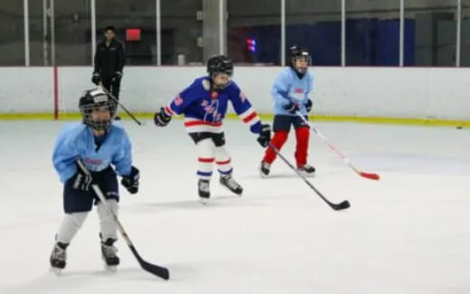 a group of people playing hockey