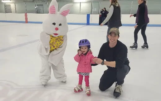 a person and a child posing with a person in a rabbit garment