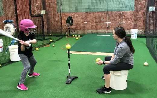 a person and a girl playing baseball