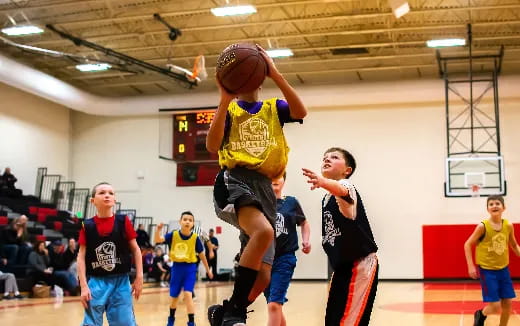 a person jumping to dunk a basketball
