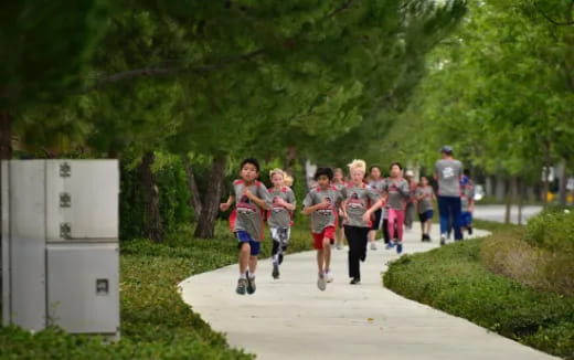 a group of people running on a path