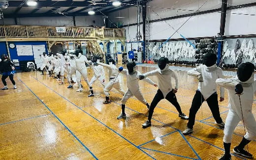 a group of people in white uniforms in a gym