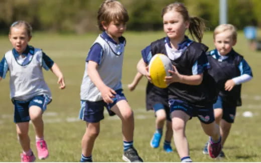 a group of kids playing football