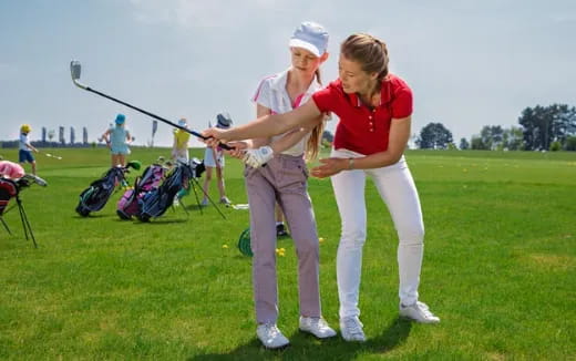 a couple of women playing golf