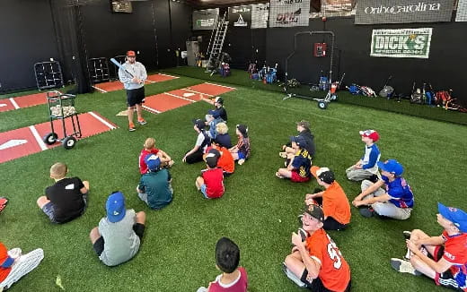 a group of people sitting on the grass