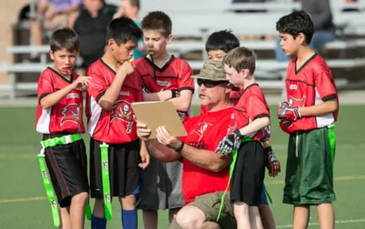 a group of boys in red uniforms