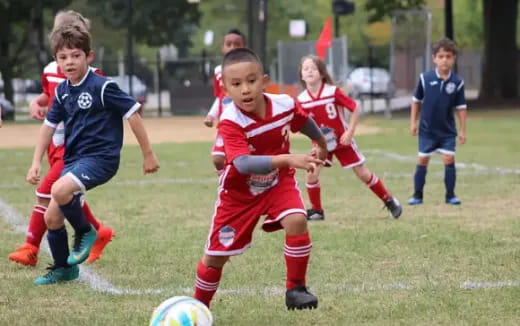 a group of kids playing football