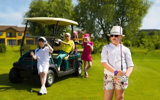 a group of people on a golf cart