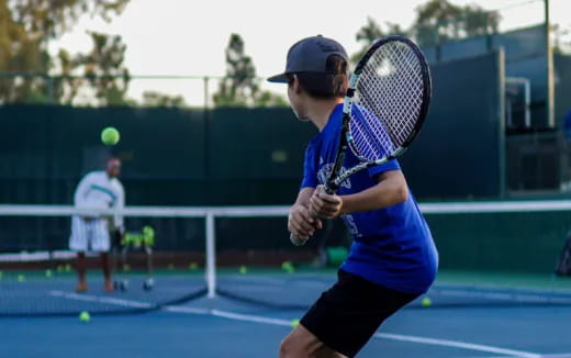 a boy playing tennis