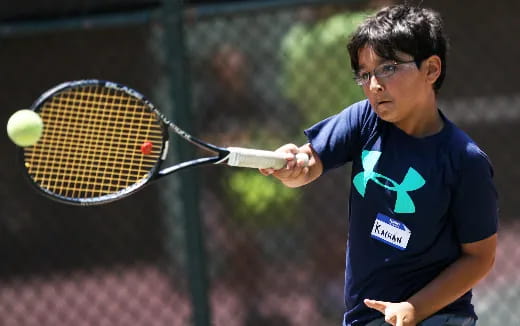 a person hitting a ball with a tennis racket